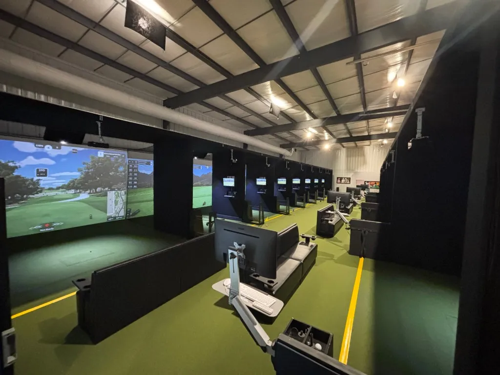 PGA-certified golf instructor working with a student at Tee24